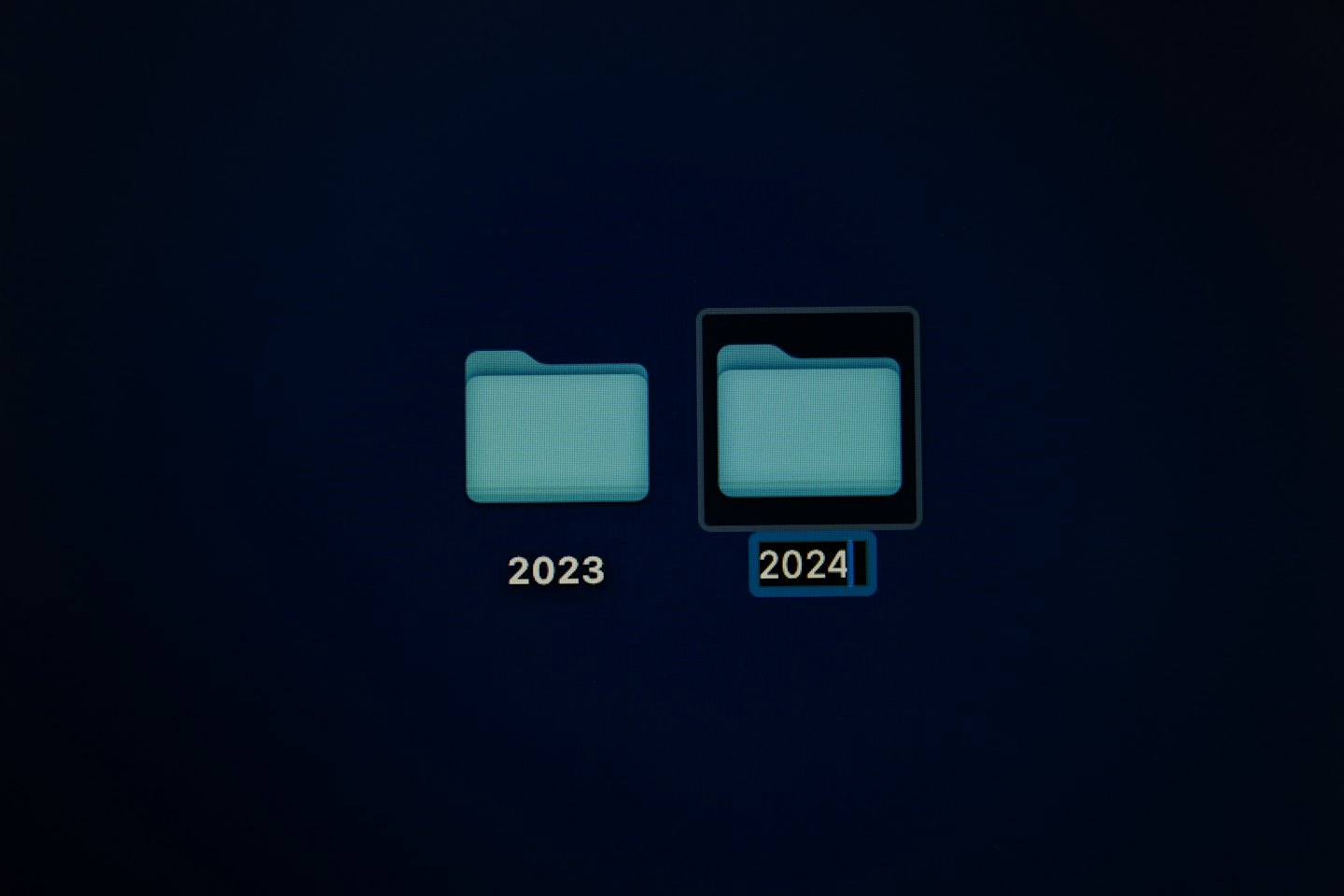 Two digital folders labeled 2023 and 2024 on a screen.